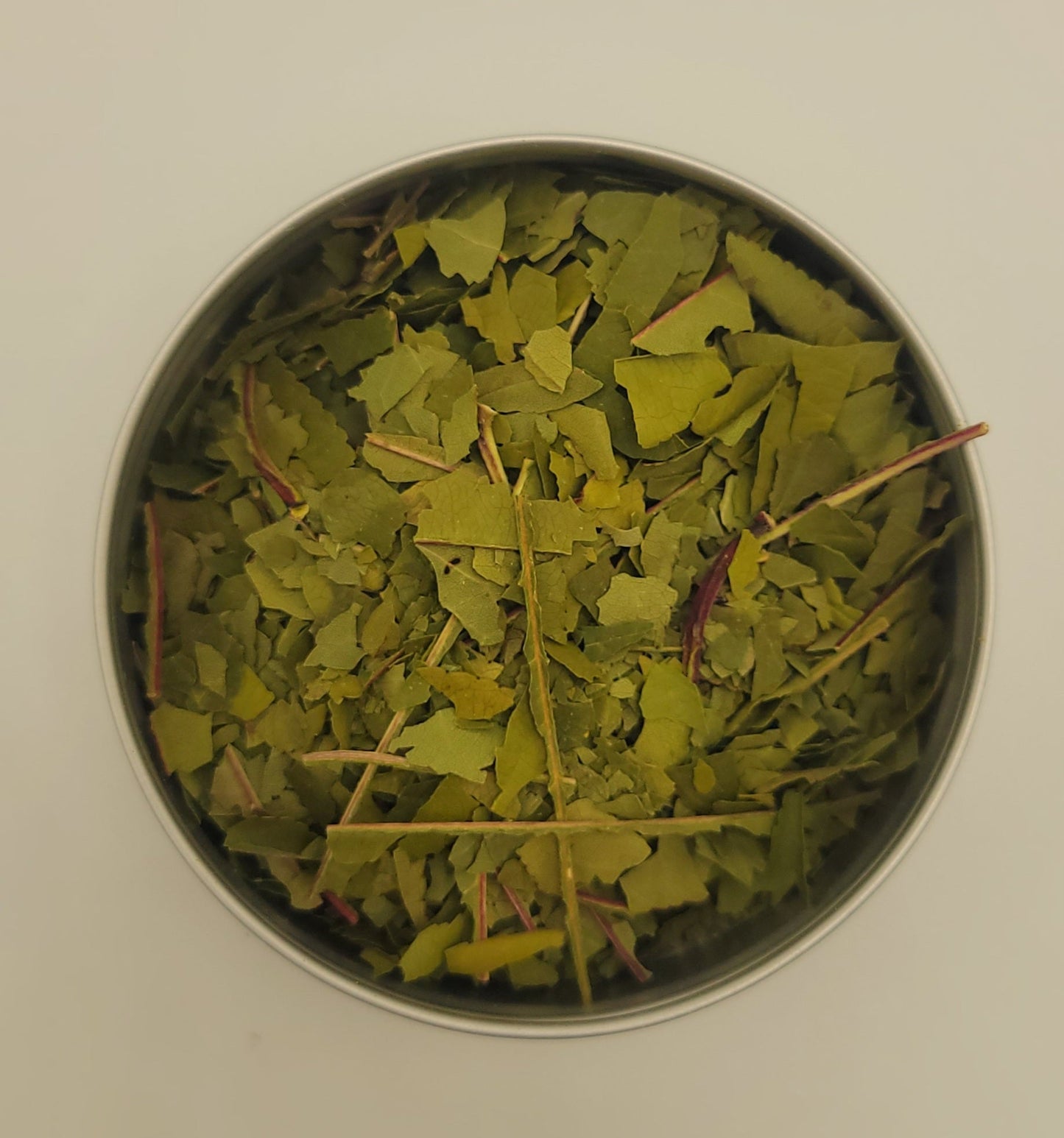 Dried peach leaf in metal dish